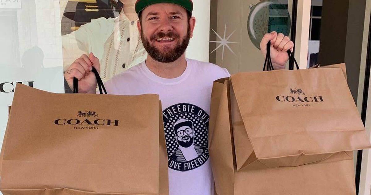 Kendall with coach bags man holding two Coach bags