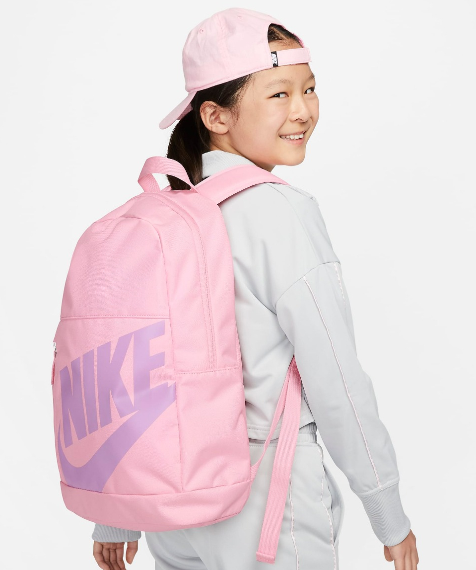 girl wearing a pink Nike backpack