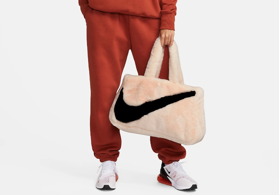 woman holding a Nike tote bag