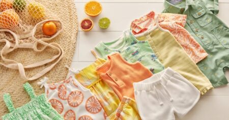 Carter's summer baby clothes laid out