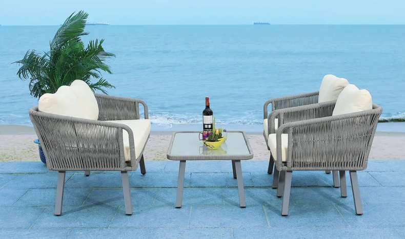 Cangelosi Person Outdoor Seating Group with Cushions loveseat and two chairs on a patio