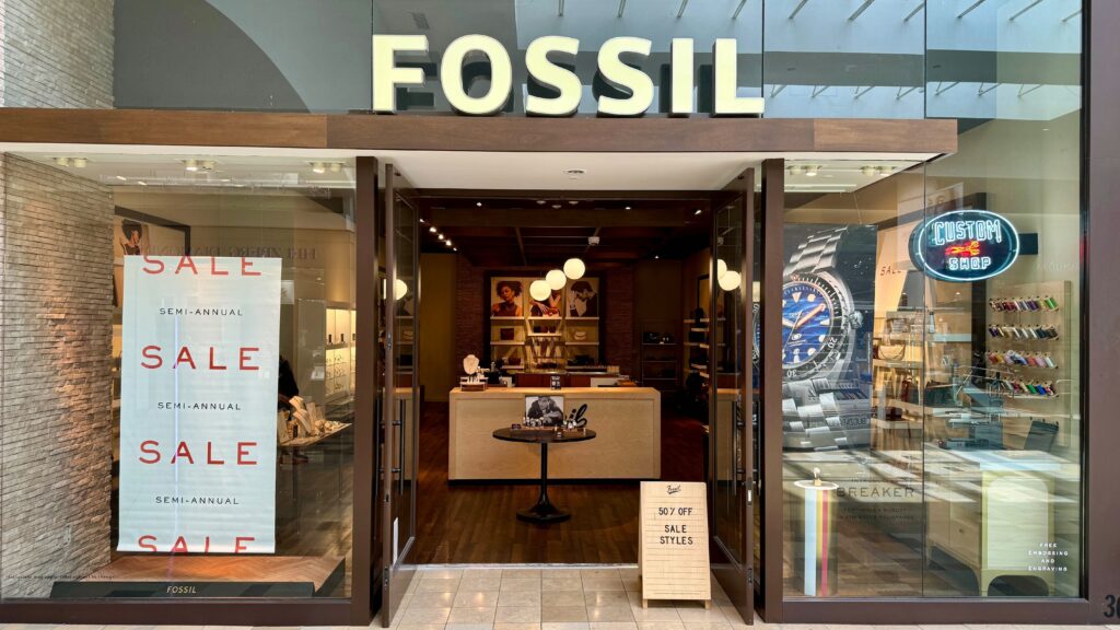 FOSSIL STORE SALE FOSSIL STORE FRONT WITH SALE SIGN IN WINDOW