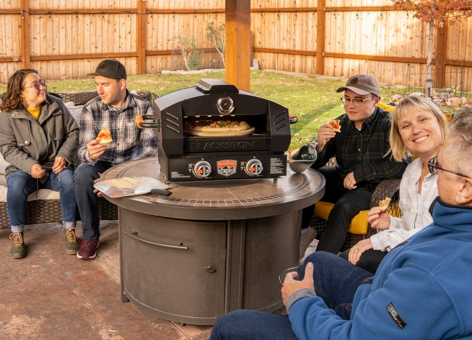 Pizza Oven Conversion Kit for Blackstone Griddle people sitting around a Blackstone pizza oven
