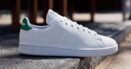 white adidas sneaker with green accent on the back