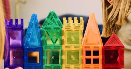 girl playing with magnet tiles
