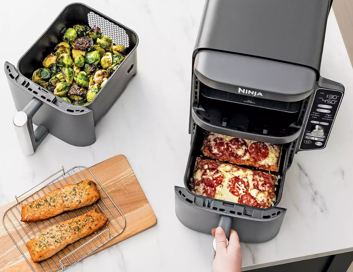 hand pulling a drawer out of a ninja air fryer