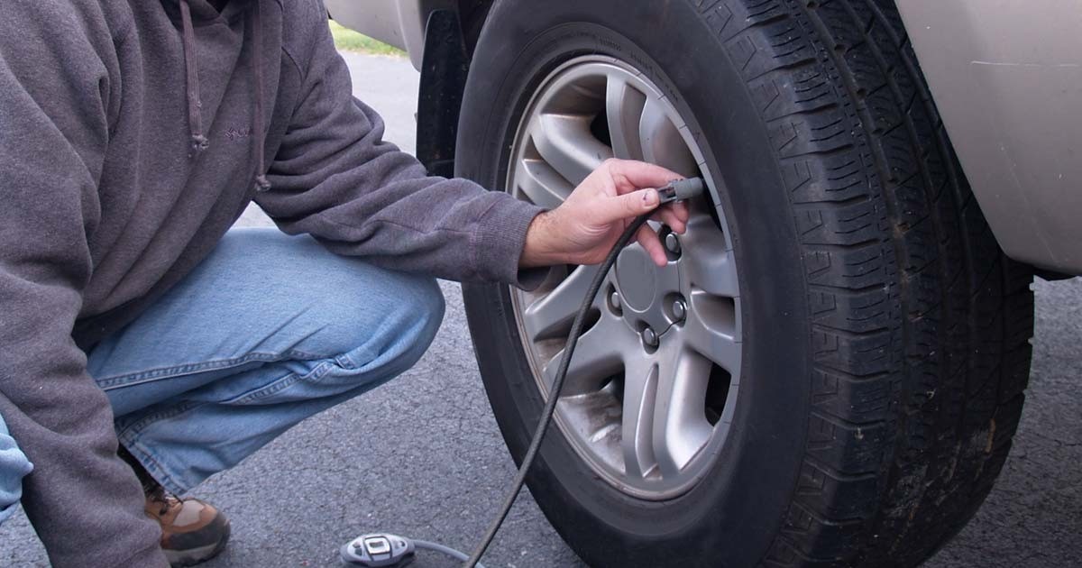 person adding air to their car tires. Free air for tires - The Freebie Guy