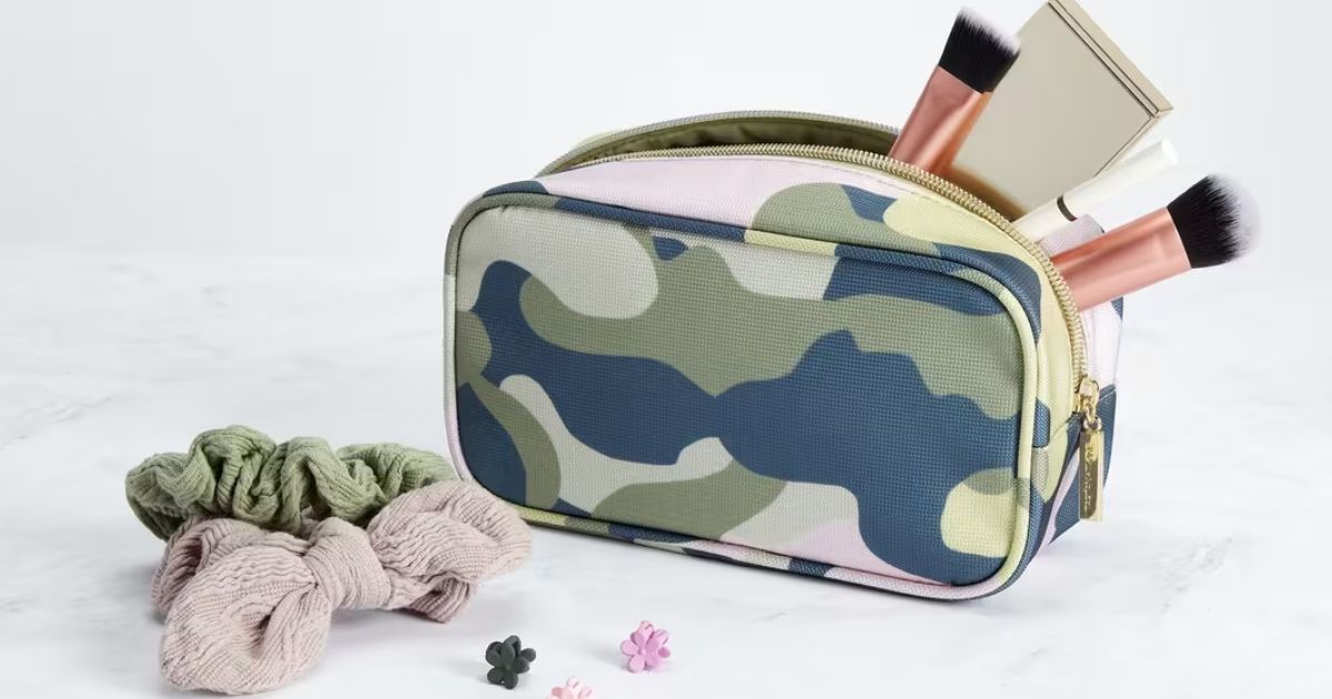 cosmetics bag with brushes hanging out of it and scrunchies next to it