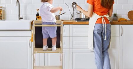 kid on a stool by a woman