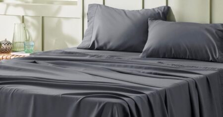 grey sheets on a bed
