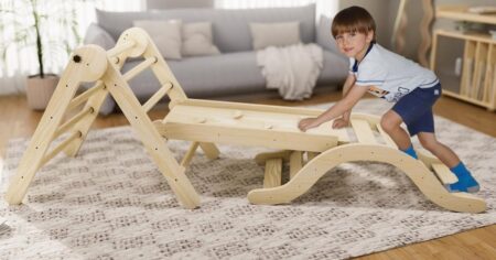 boy climbing on a Pikler toy set