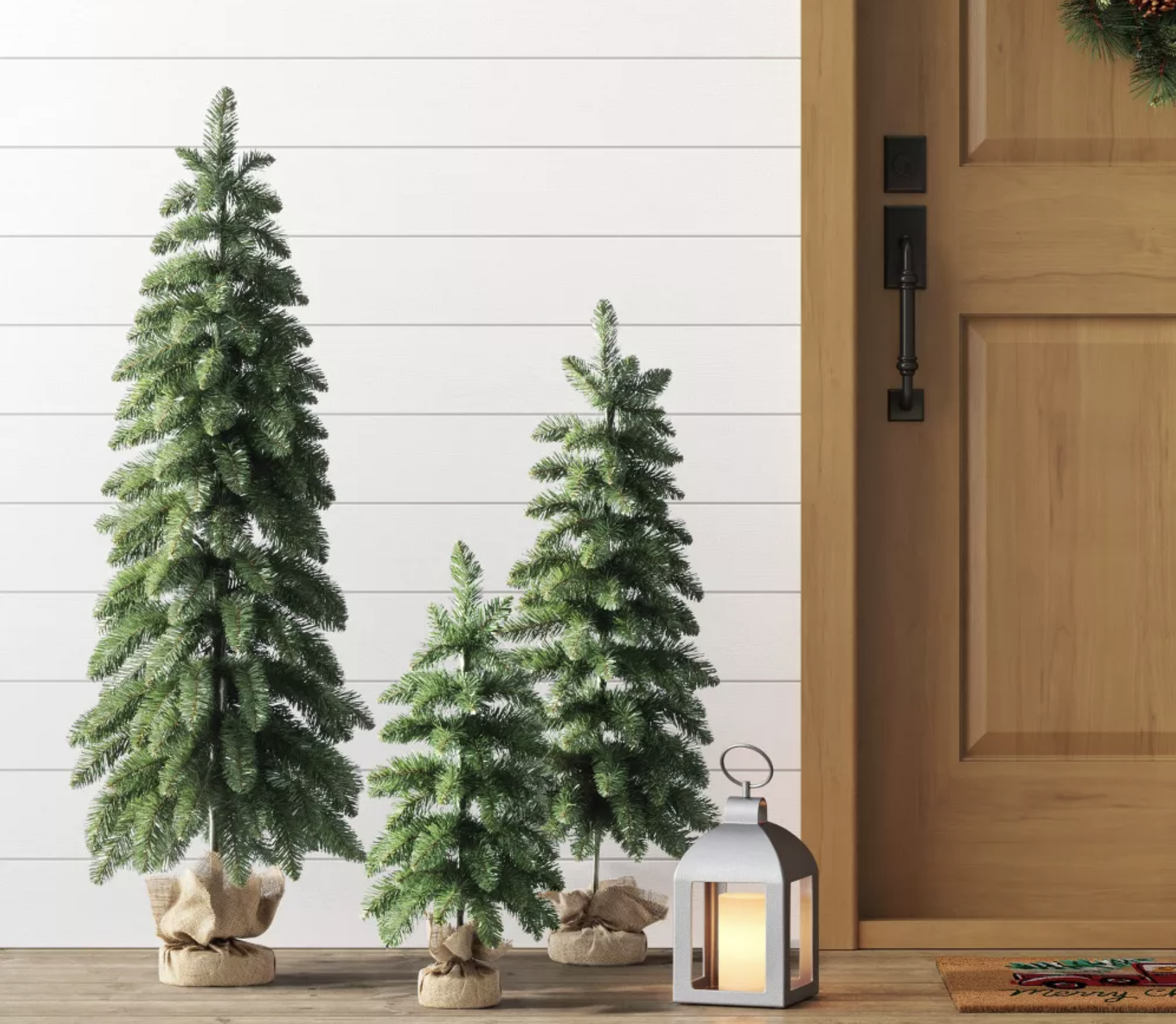 3pc Unlit Downswept Alberta Spruce Mini Artificial Christmas Trees with Burlap Base trees on a porch
