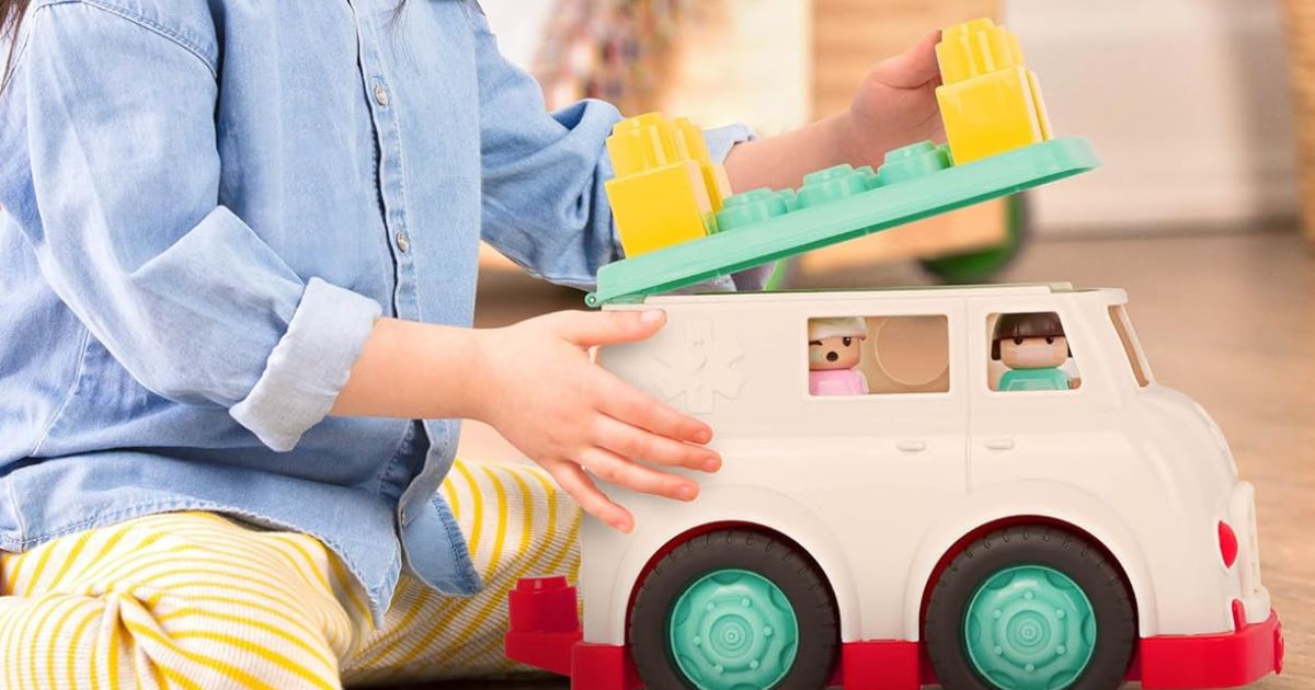 kid playing with a toy rescue truck
