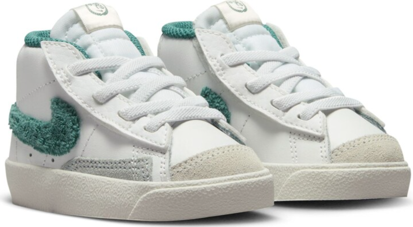 pair of white Nike sneakers with green accents