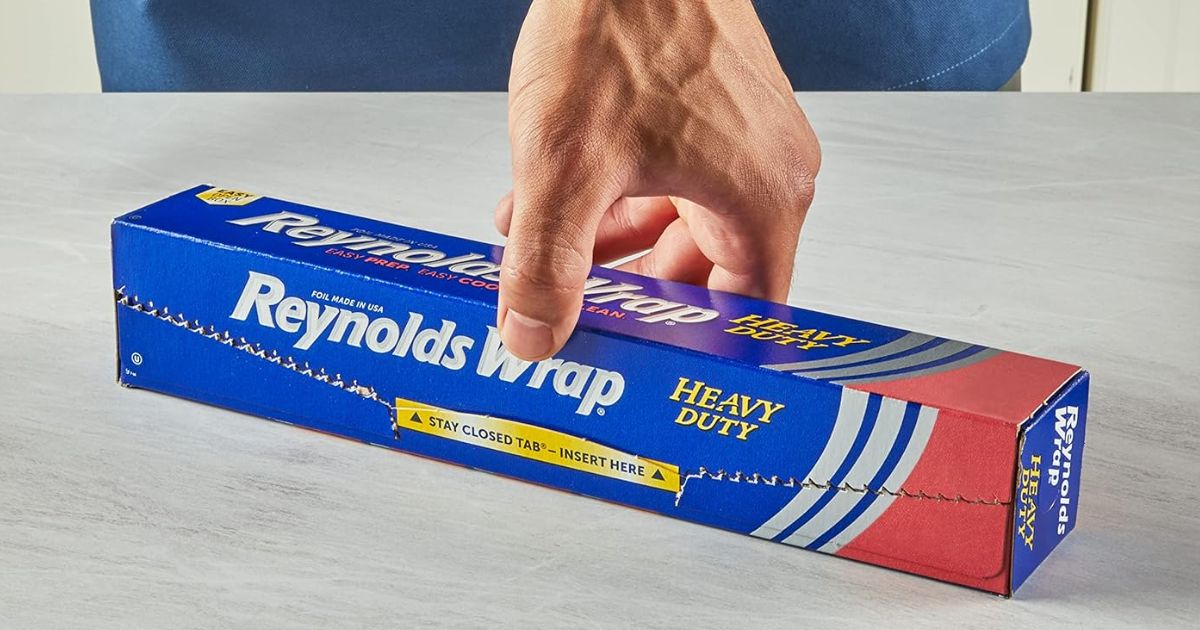 hand holding a box of Reynolds Wrap