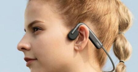 woman wearing Shokz headphones