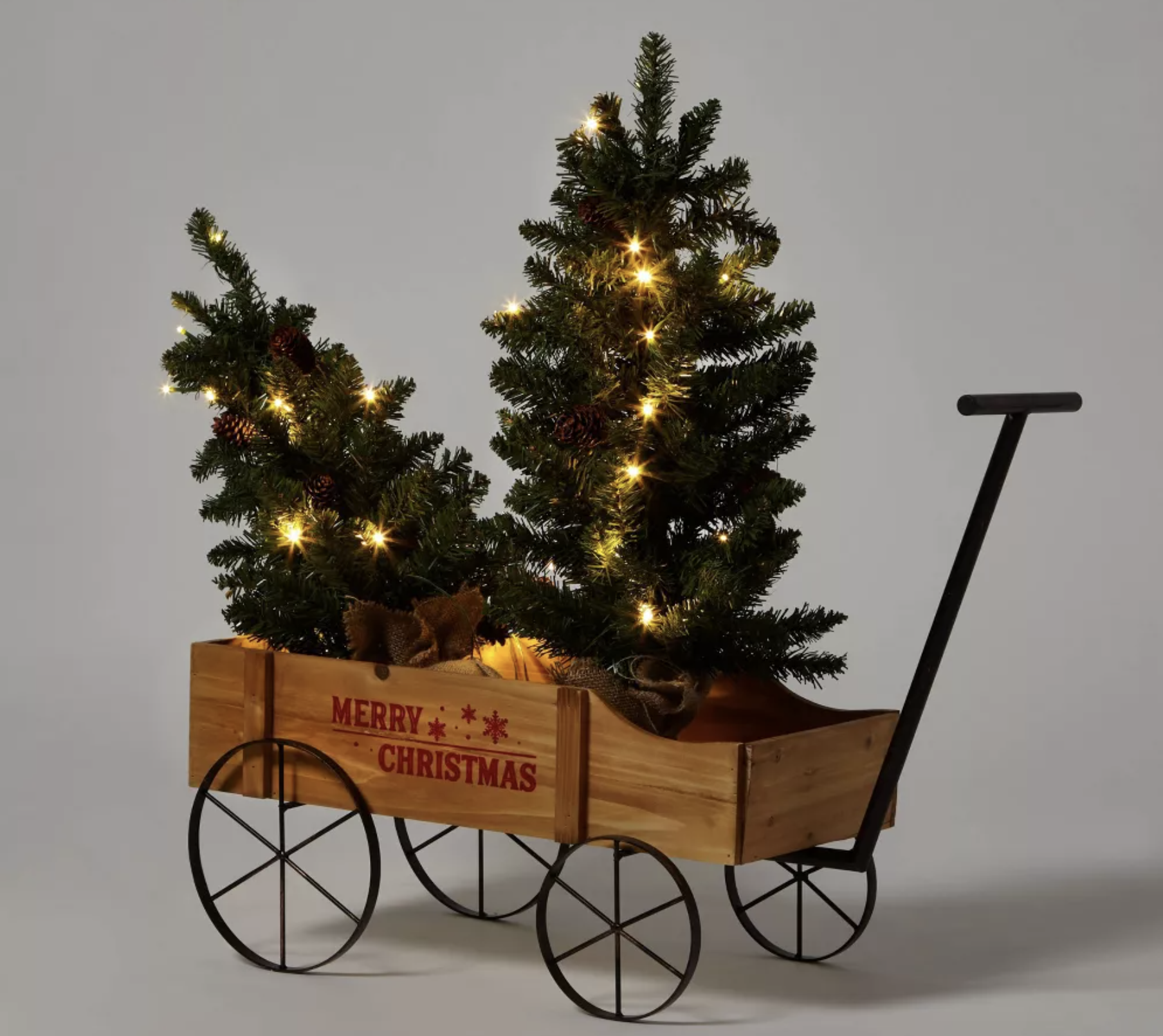 wagon with artificial Christmas trees in it