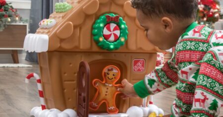 kid playing with a Step2 Gingerbread house