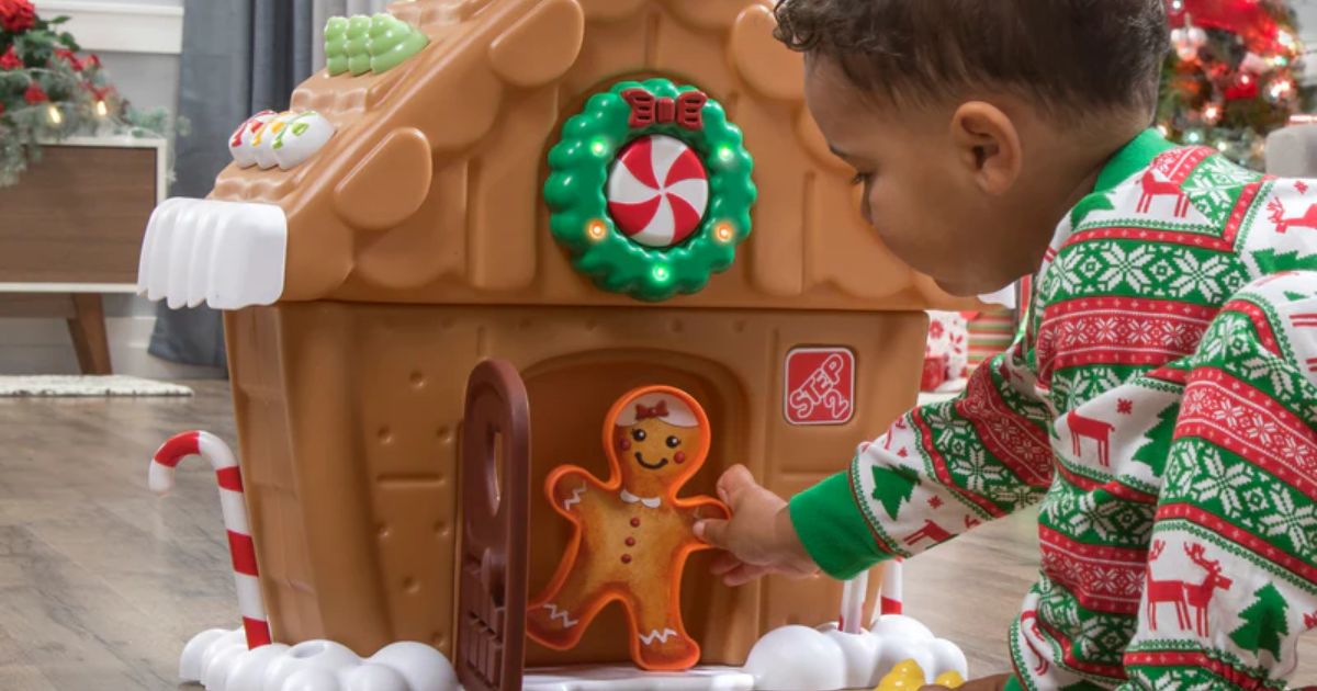 kid playing with a Step2 Gingerbread house