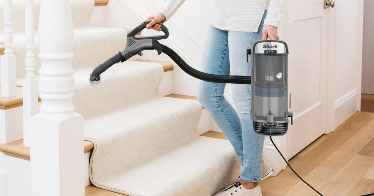 woman using a Shark vacuum